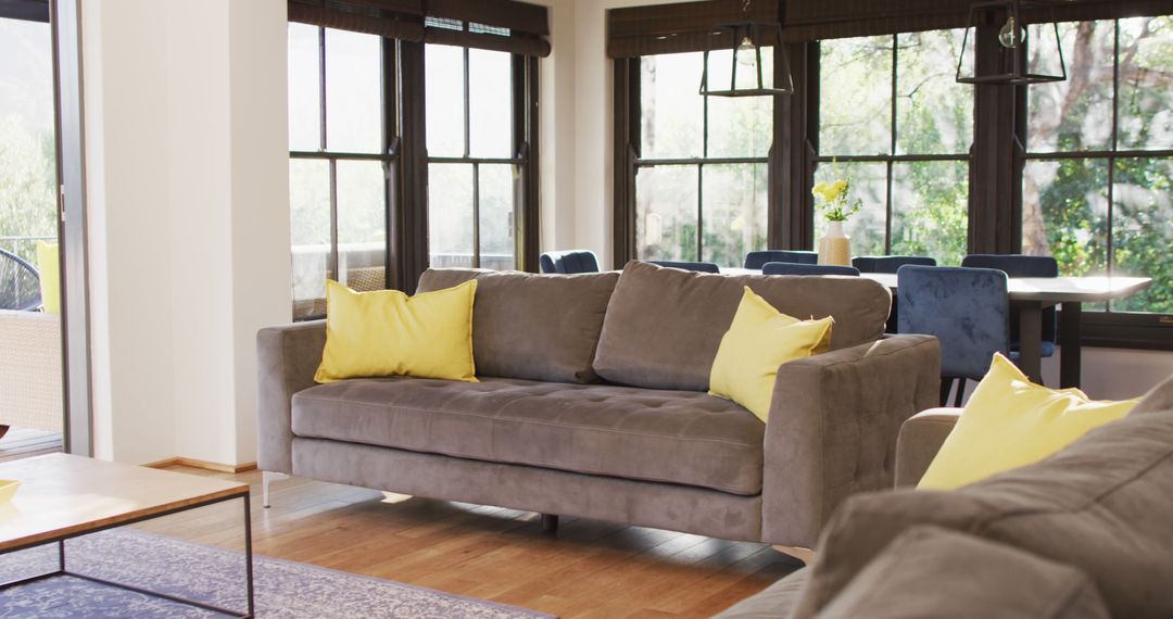 Modern Living Room with Cozy Gray Sofa and Yellow Accents - Free Images, Stock Photos and Pictures on Pikwizard.com