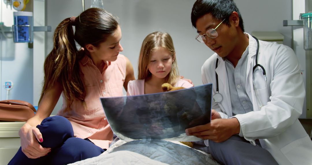 Doctor Explaining X-Ray Results to Concerned Child and Mother in Hospital - Free Images, Stock Photos and Pictures on Pikwizard.com