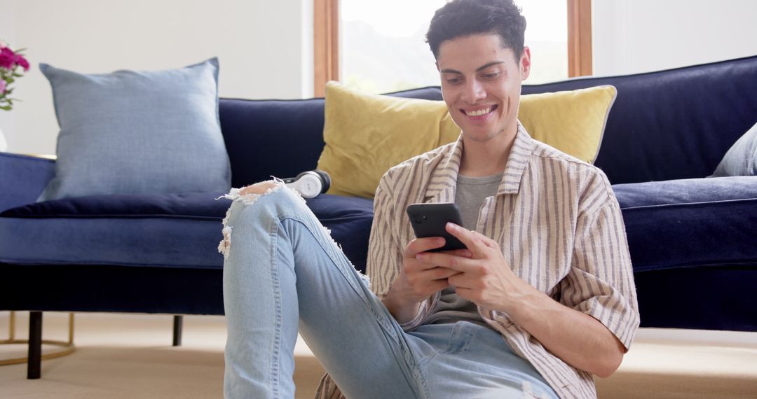 Happy Man Using Smartphone in Modern Living Room