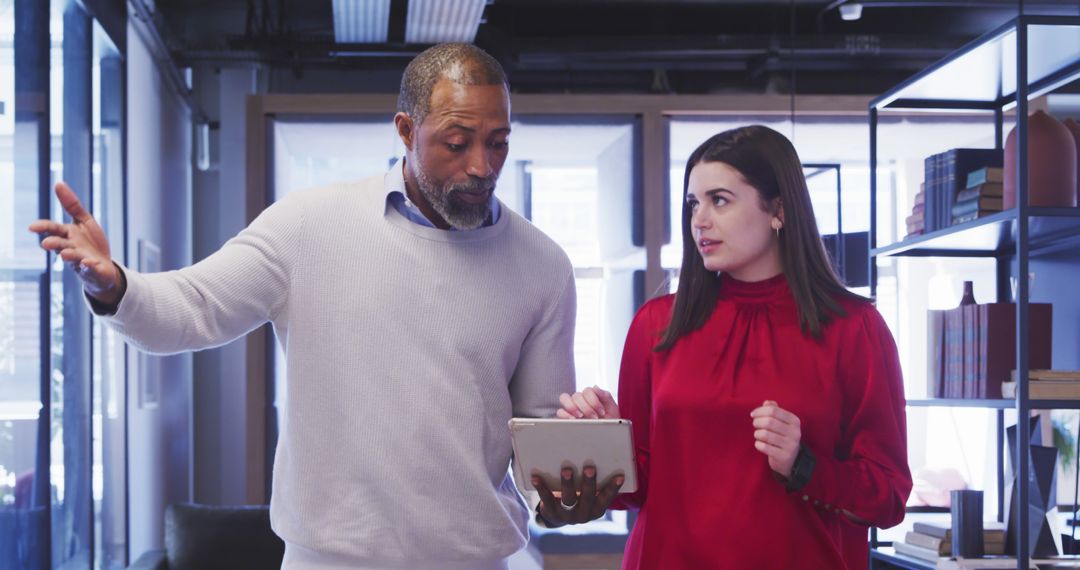 Diverse Colleagues Discuss Project in Modern Office