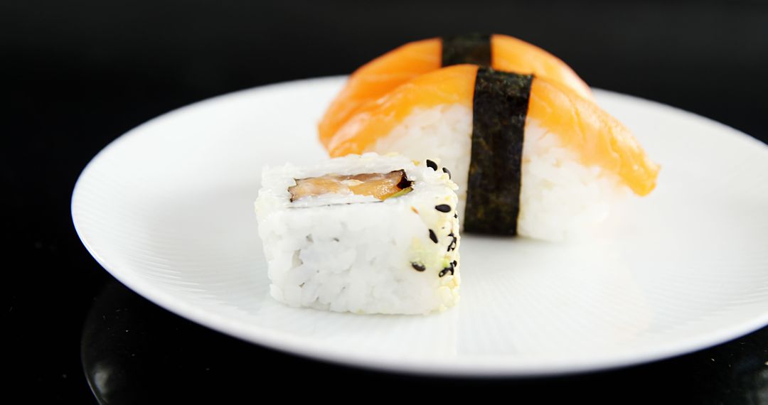 Close-Up of Delicious Sushi on White Plate, Isolated on Black Background - Free Images, Stock Photos and Pictures on Pikwizard.com