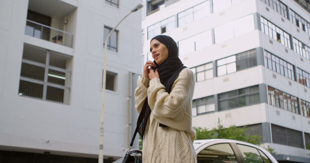 Confident Muslim Woman Talking on Smartphone in Urban Environment - Free Images, Stock Photos and Pictures on Pikwizard.com