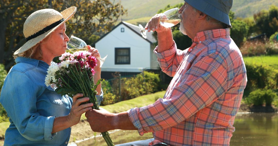 Senior Couple Enjoying Wine and Flowers Outdoors - Free Images, Stock Photos and Pictures on Pikwizard.com