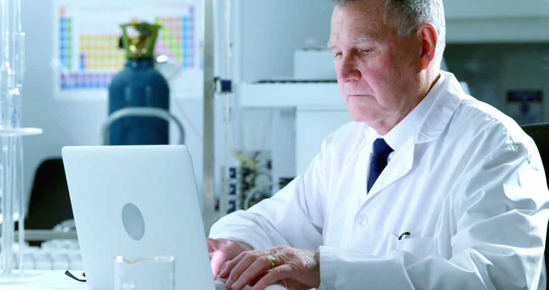 Senior Scientist Analyzing Data on Laptop in Lab - Free Images, Stock Photos and Pictures on Pikwizard.com