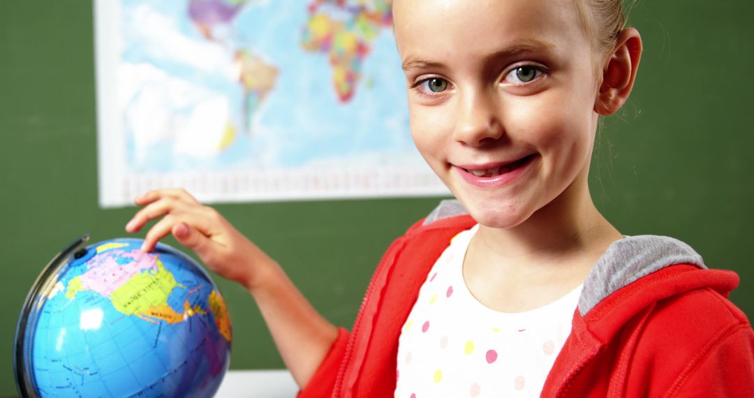 Happy Schoolgirl Exploring Globe in Classroom Setting