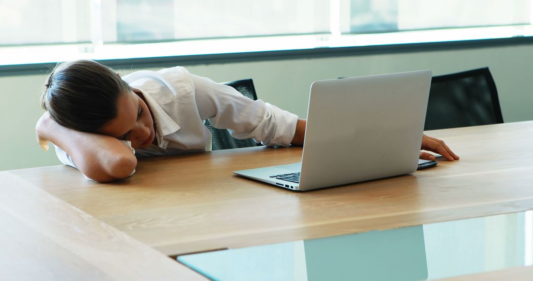 Exhausted Businesswoman Resting in Office by Laptop - Free Images, Stock Photos and Pictures on Pikwizard.com