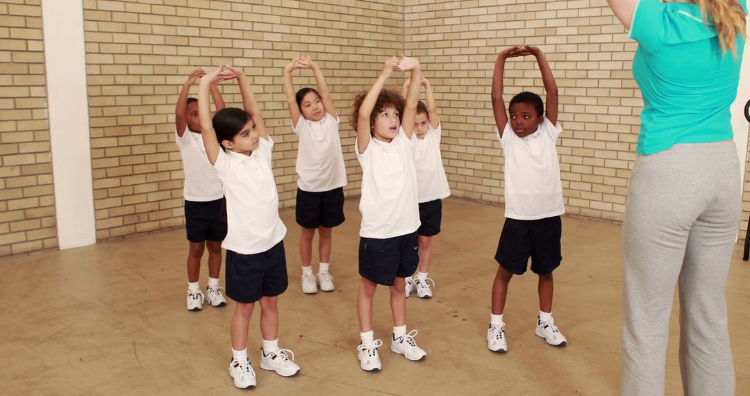 Children Stretching with Instructor During PE Class - Free Images, Stock Photos and Pictures on Pikwizard.com