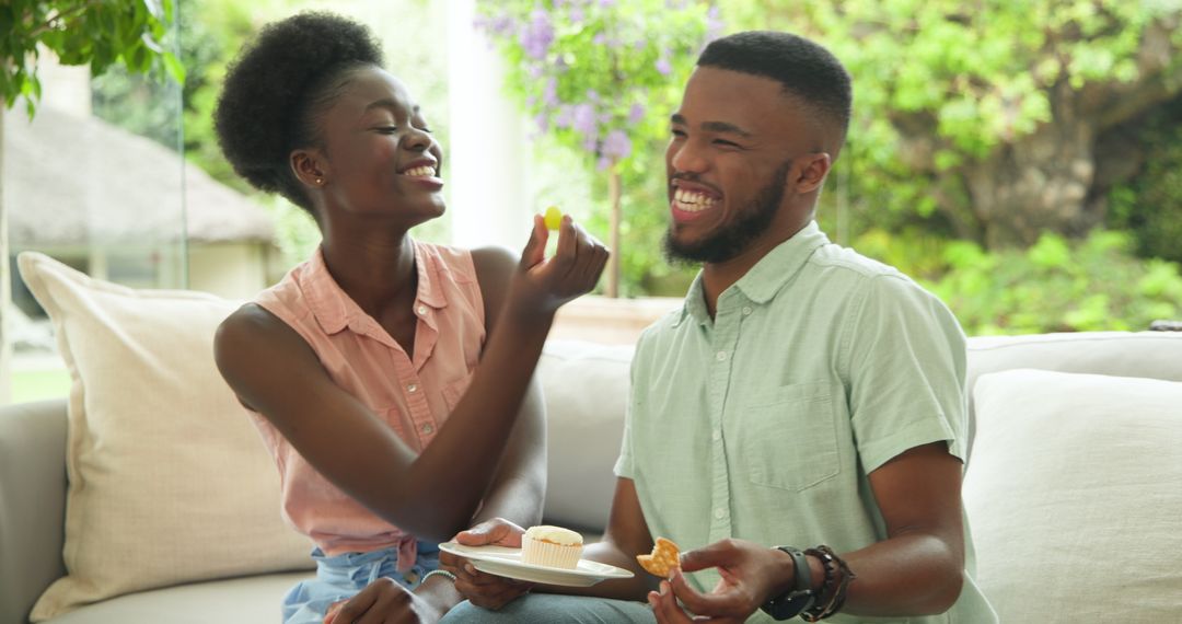 Joyful Couple Enjoying Cupcakes on Relaxing Patio