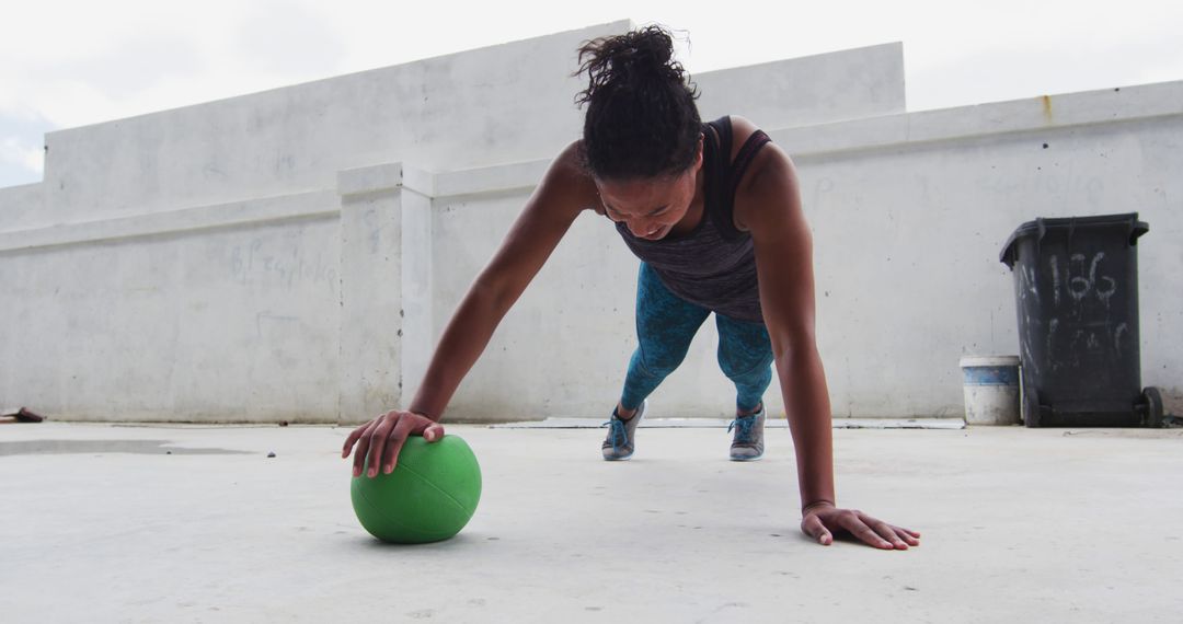 Woman Doing Outdoor Push-ups with Green Exercise Ball - Free Images, Stock Photos and Pictures on Pikwizard.com