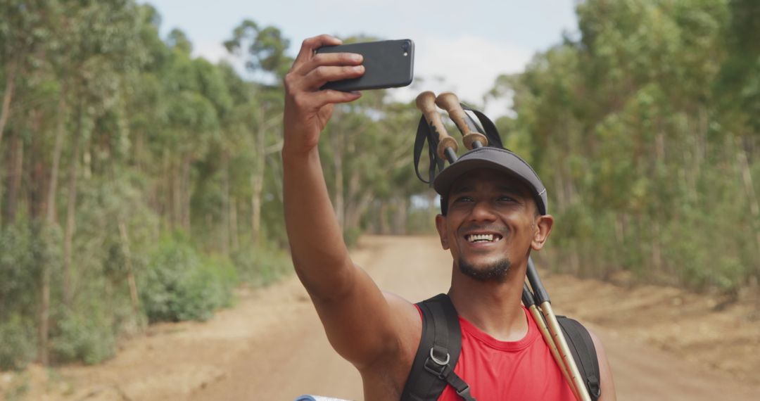 Excited Hiker Taking a Selfie in Scenic Forest Path - Free Images, Stock Photos and Pictures on Pikwizard.com