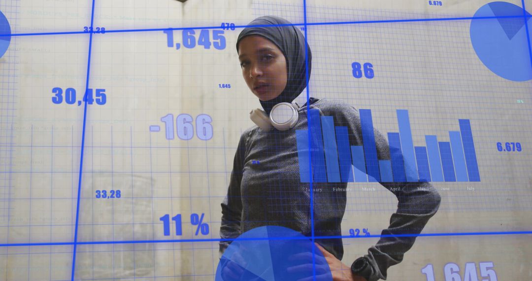 Confident Biracial Professional in Hijab with Digital Graphs