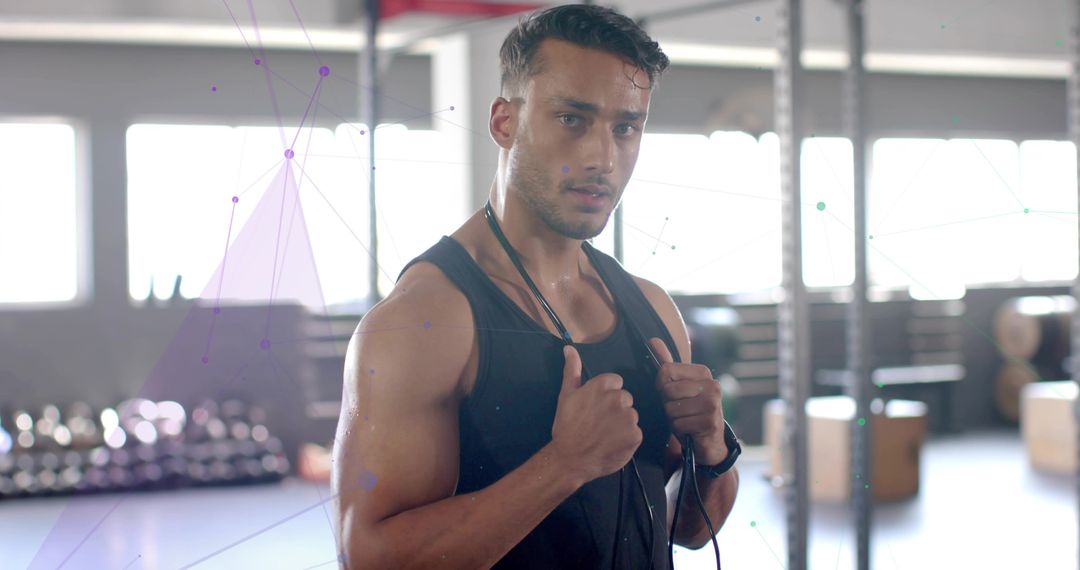 Motivated Man Training with Jump Rope in Modern Gym Environment