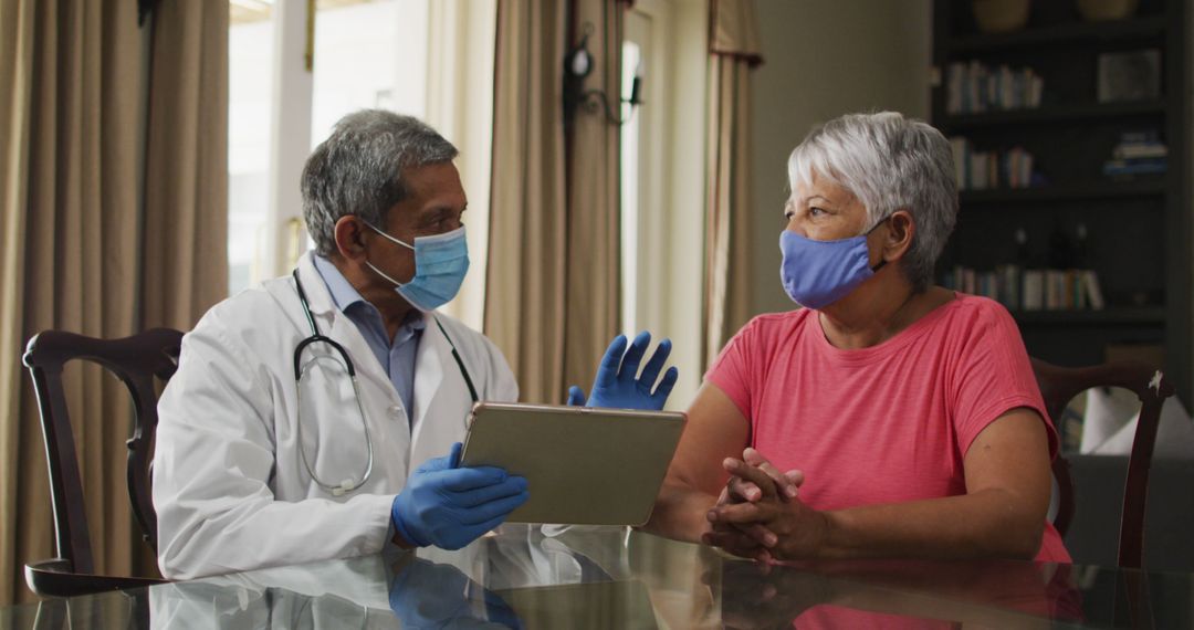 Doctor Discussing Health with Senior Woman During Home Visit - Free Images, Stock Photos and Pictures on Pikwizard.com