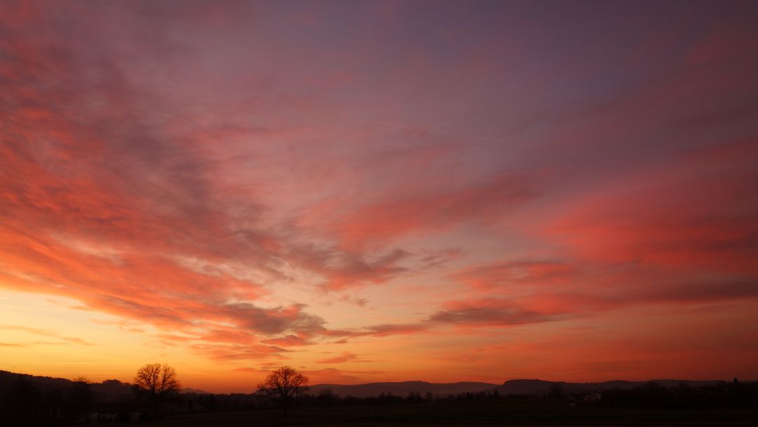 Stunning Sunset with Vibrant Clouds Over Scenic Landscape - Free Images, Stock Photos and Pictures on Pikwizard.com