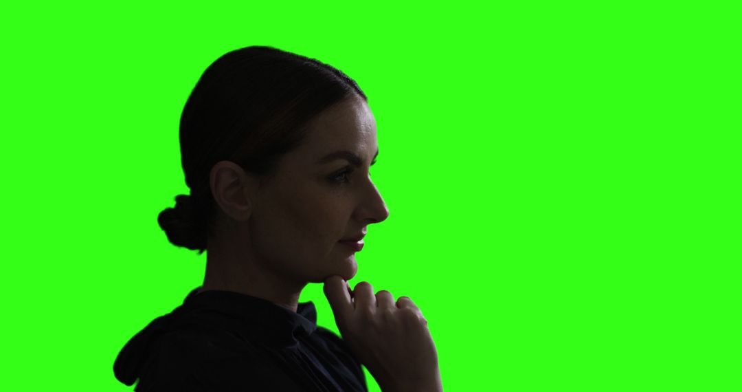 Silhouette of a Pensive Woman on a Green Background - Free Images, Stock Photos and Pictures on Pikwizard.com