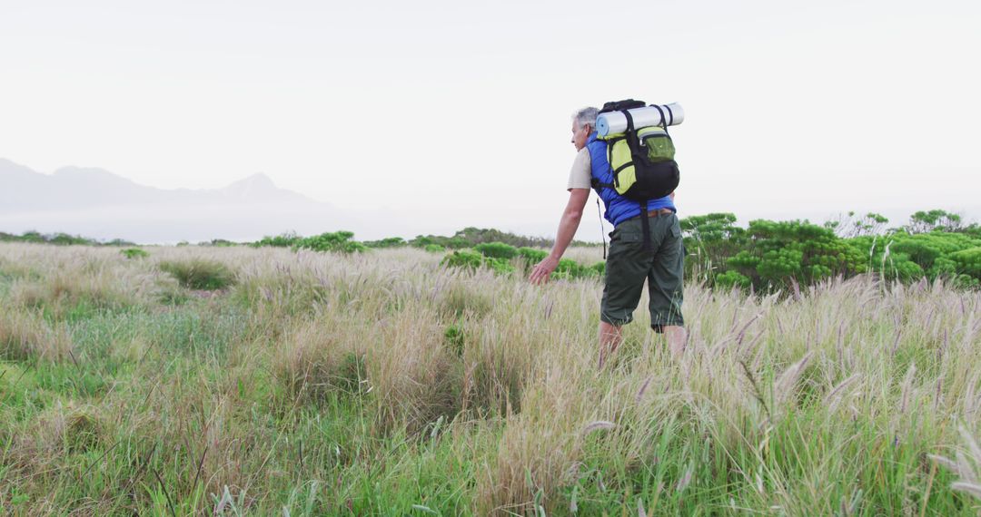 Senior Hiker Exploring Wild Mountain Field