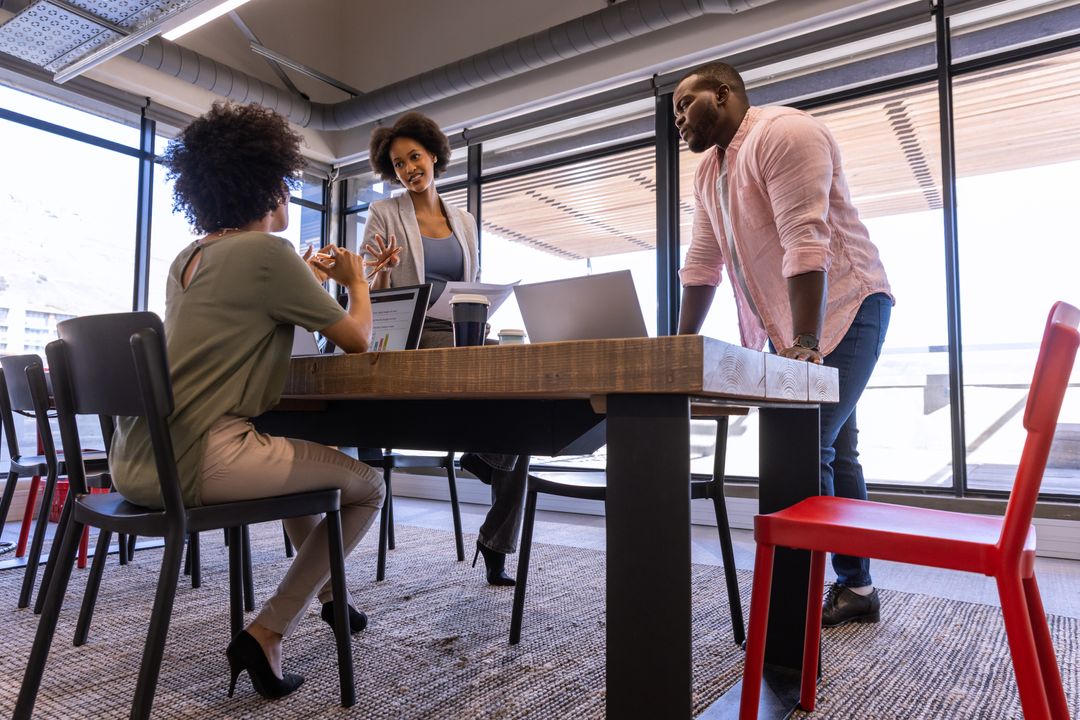 Team Collaborating on Project Plans in Modern Office Environment
