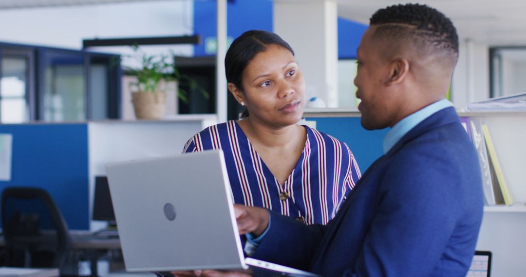 Business Discussion in Office with Laptop Analysis