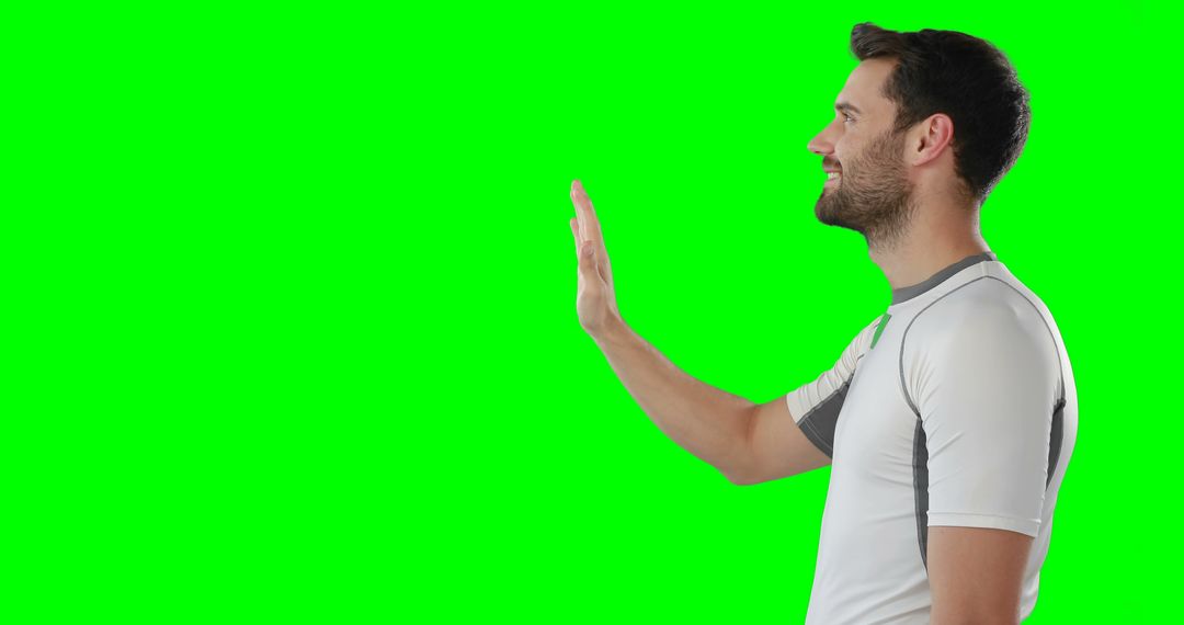 Man Waving and Smiling in White Athletic Wear on Green Screen - Free Images, Stock Photos and Pictures on Pikwizard.com