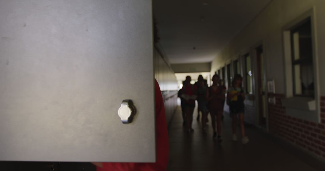 Child Opening School Locker in Busy Hallway