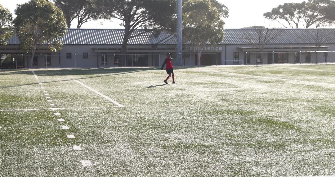 Soccer Player Preparing for Morning Practice on Field
