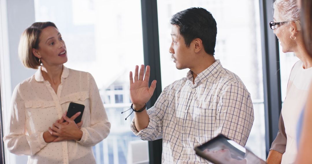 Business Team Engaged in Collaborative Office Meeting with Technology