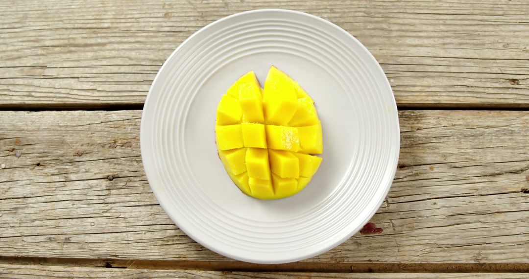 Sliced Mango on White Plate, Rustic Wood Background - Free Images, Stock Photos and Pictures on Pikwizard.com