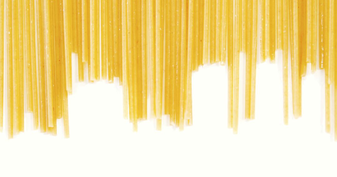 Close-Up of Dried Spaghetti Pasta Hanging on White Background - Free Images, Stock Photos and Pictures on Pikwizard.com