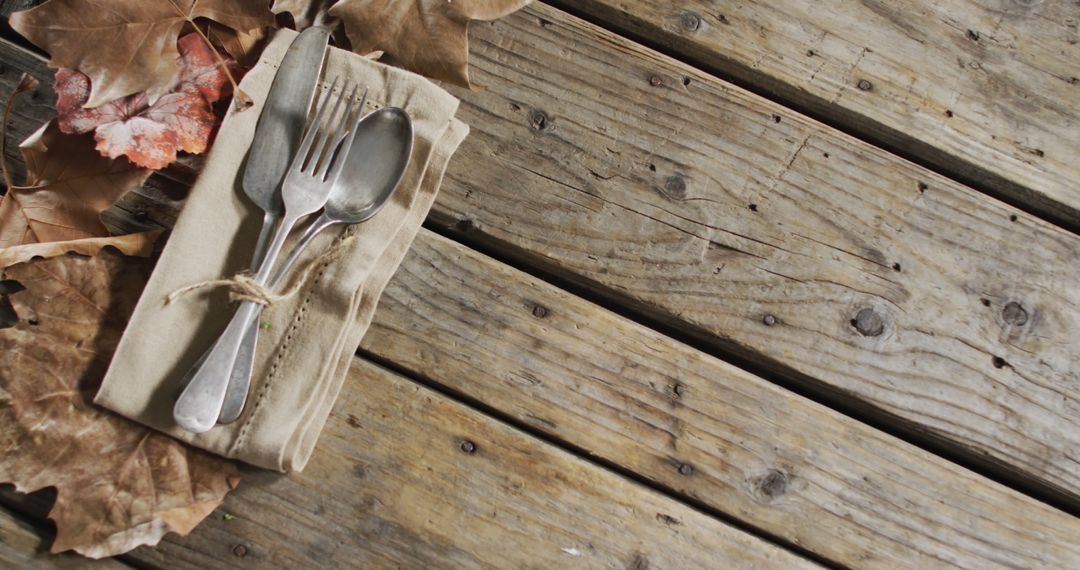 Rustic Silverware on Wooden Table with Autumn Leaves - Free Images, Stock Photos and Pictures on Pikwizard.com