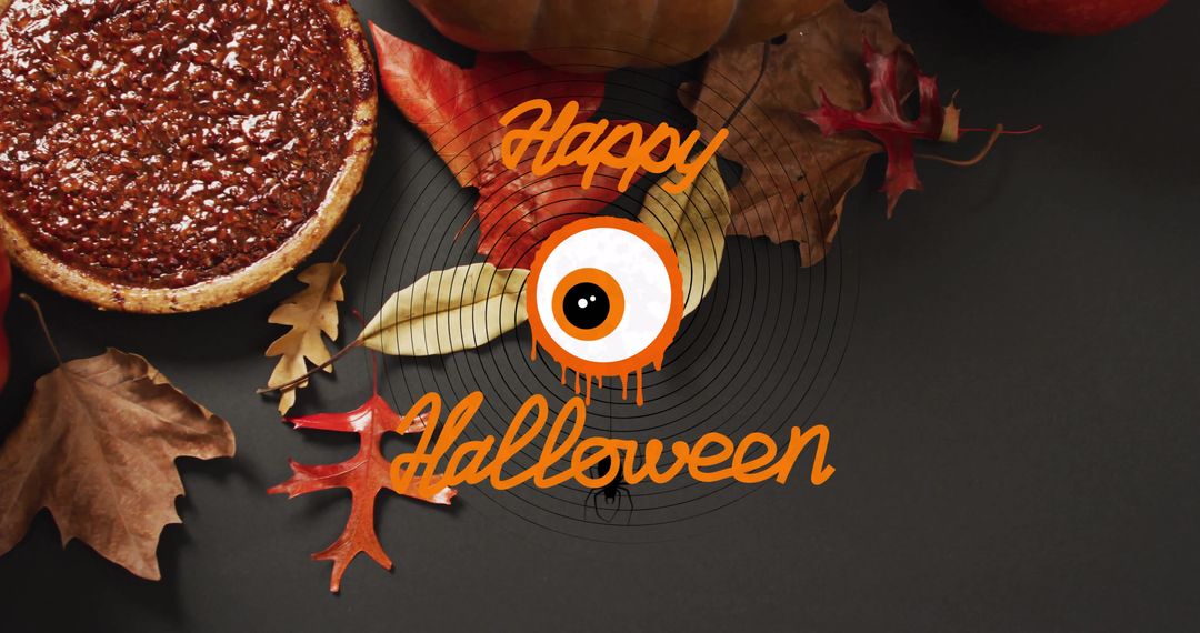 Happy Halloween Celebration with Eyeball Text Over Autumn Leaves and Pumpkin Pie