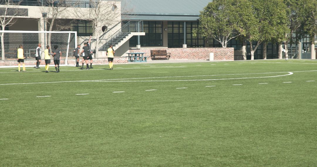 Group of Soccer Players Practicing on School Field