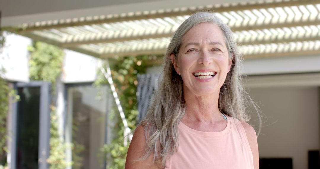 Cheerful Mature Woman with Natural Gray Hair Smiling Outdoors - Free Images, Stock Photos and Pictures on Pikwizard.com