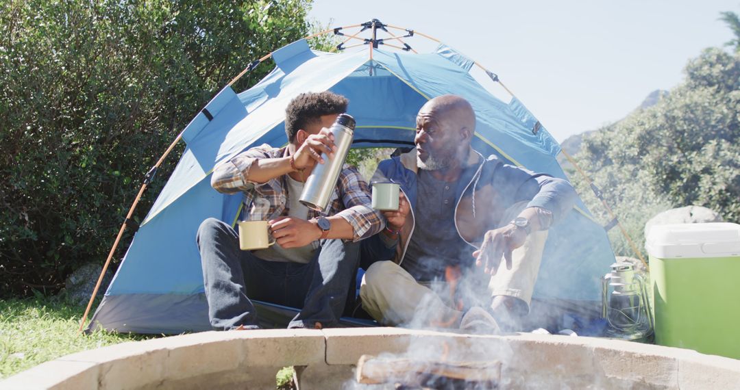 Father and Son Camping Near Tent with Thermos and Mug - Free Images, Stock Photos and Pictures on Pikwizard.com