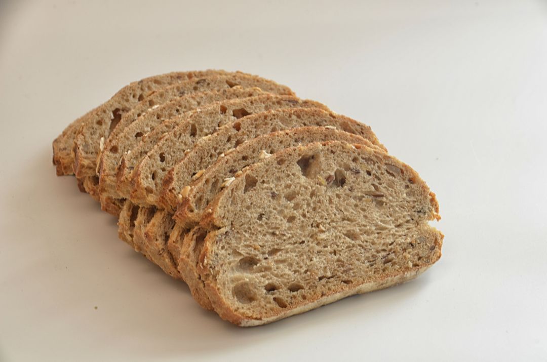 Freshly Sliced Rustic Multigrain Bread on White Background - Free Images, Stock Photos and Pictures on Pikwizard.com