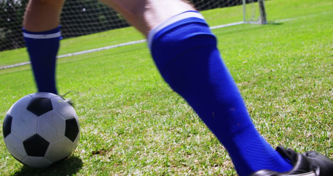 Dynamic Soccer Action with Player Engaging Ball on Lush Green Field