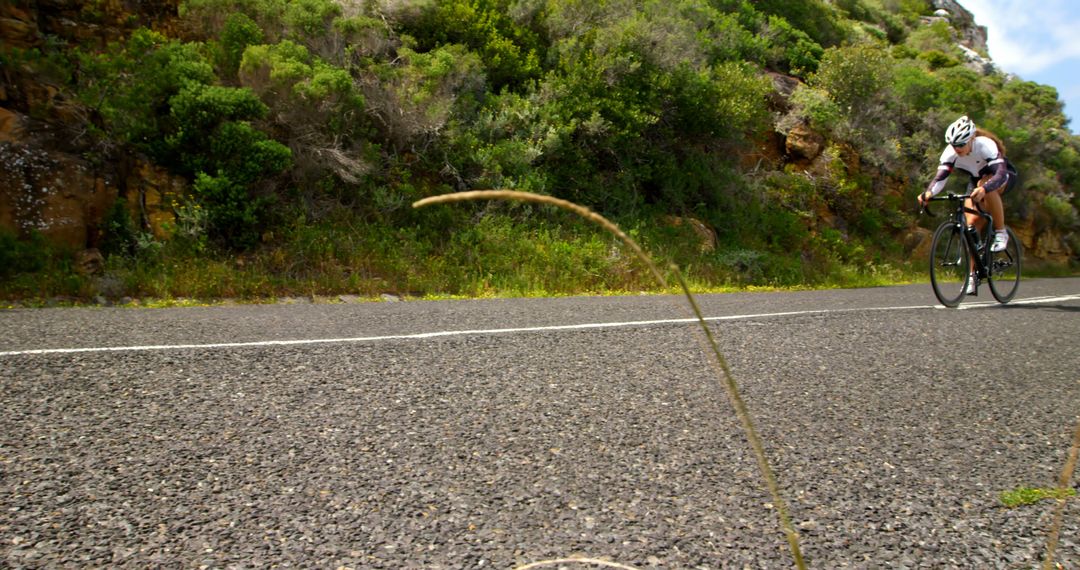 Cyclist Riding on Mountain Road Surrounded by Greenery - Free Images, Stock Photos and Pictures on Pikwizard.com