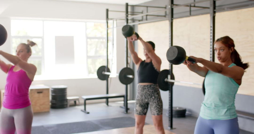 Women Exercising with Kettlebells in Gym - Free Images, Stock Photos and Pictures on Pikwizard.com