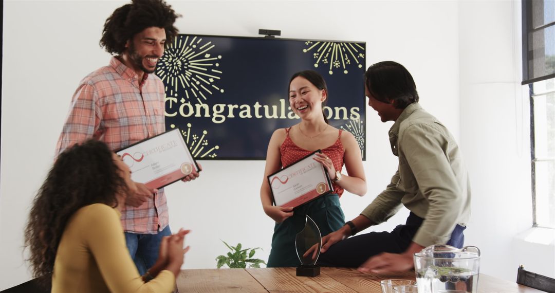 Diverse Team Celebrate Success with Certificates in Office