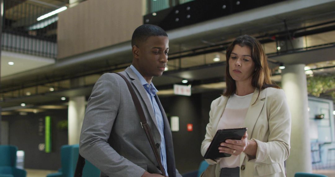Professional Colleagues Collaborating in Modern Office Lobby