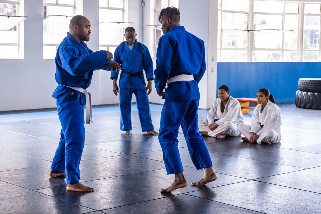 Martial Arts Training Class with Instructor and Students in Gi Uniforms
