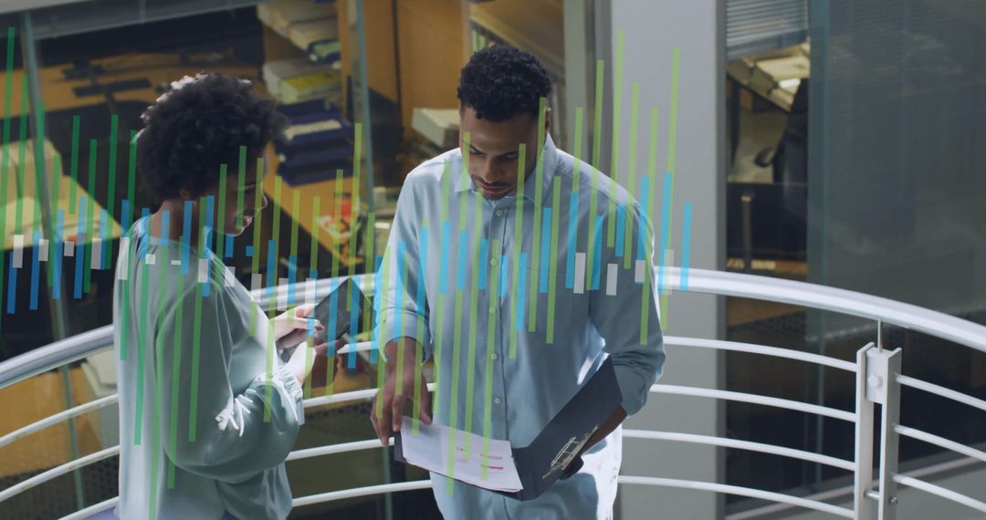 Colleagues Discussing Project with Digital Infographics in Office