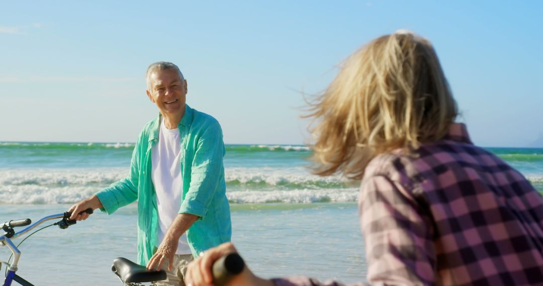 Active Senior Couple Enjoying Bicycles on Beach