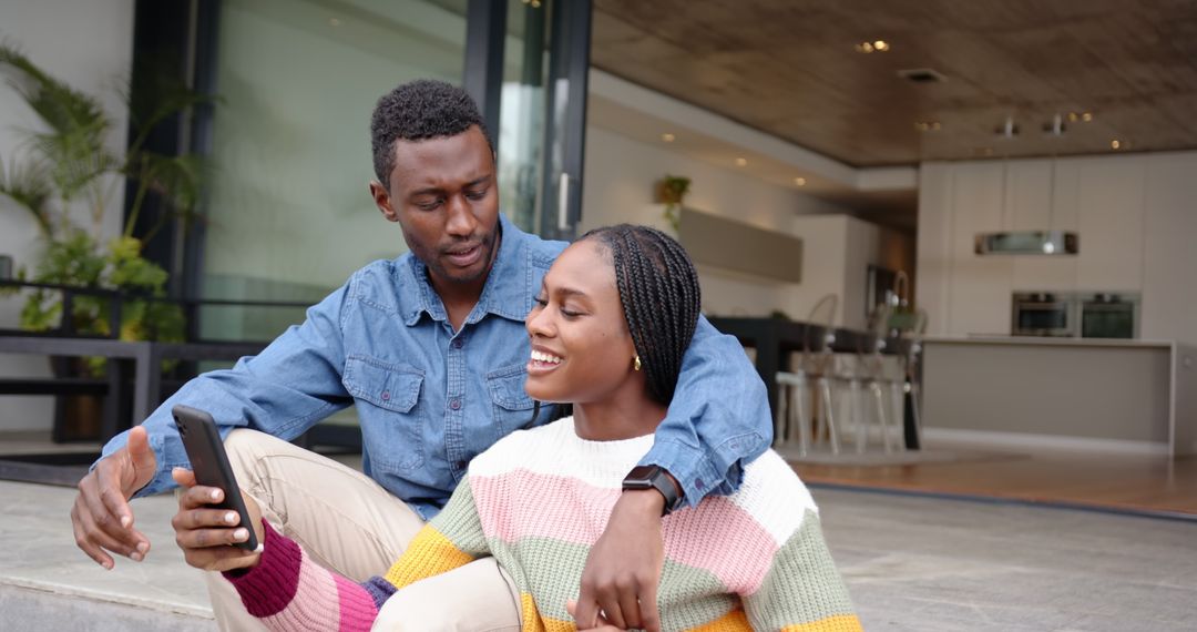 Happy Couple Enjoys Outdoor Leisure Time with Smartphone