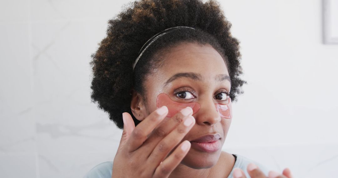 Woman Applying Eye Patches for Skincare Routine - Free Images, Stock Photos and Pictures on Pikwizard.com