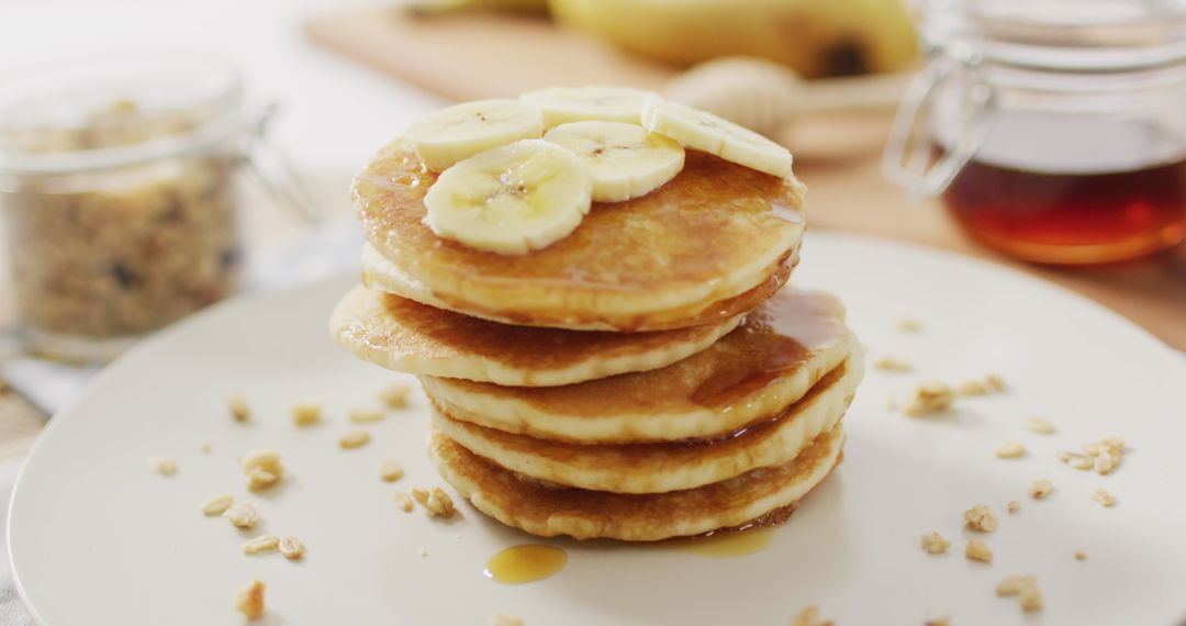 Delicious Fluffy Pancakes with Sliced Bananas and Maple Syrup