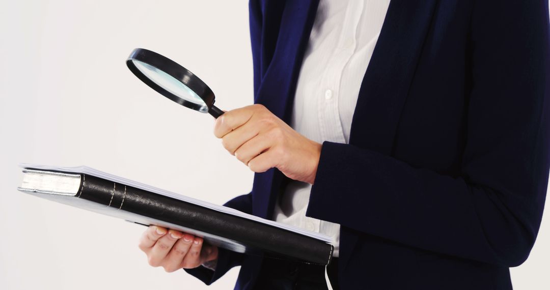 Businesswoman Examining Documents with Magnifying Glass - Free Images, Stock Photos and Pictures on Pikwizard.com