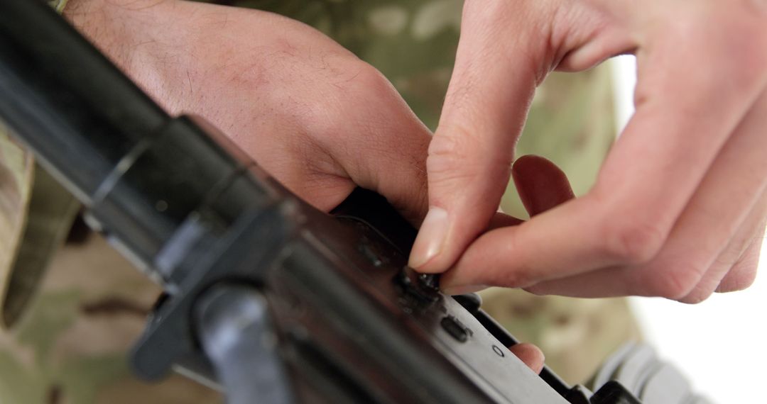 Close-Up of Hands Cleaning Firearm with Attention to Detail