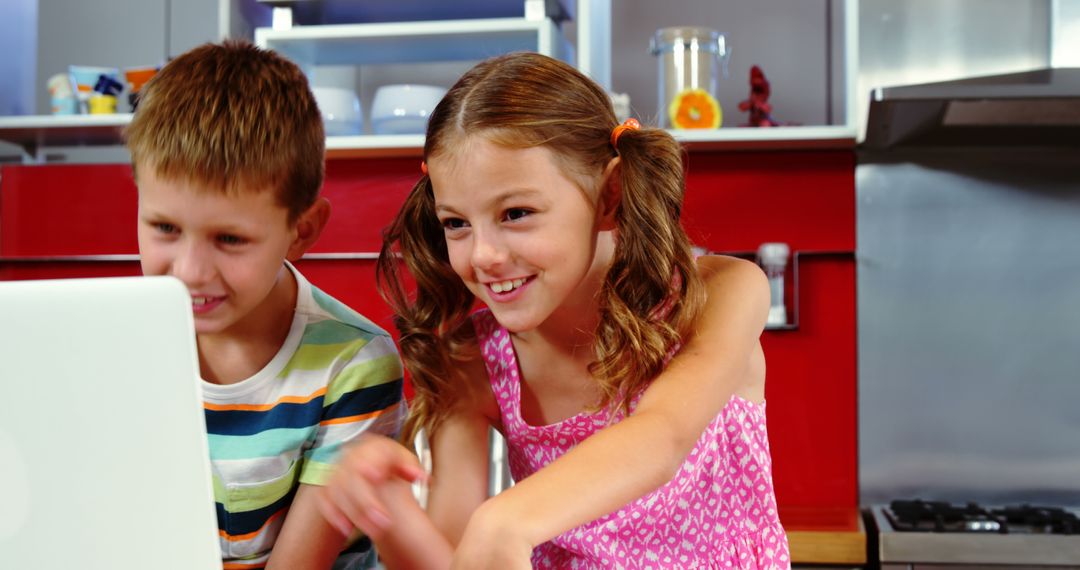 Happy Children Using Laptop in Fun Modern Kitchen - Free Images, Stock Photos and Pictures on Pikwizard.com