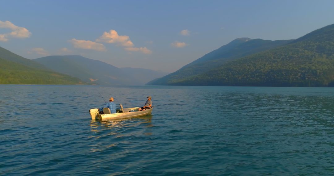 Senior Men Fishing on Tranquil Mountain Lake at Sunset - Free Images, Stock Photos and Pictures on Pikwizard.com