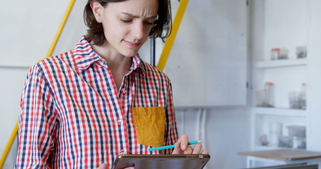 Focused Woman Updating Inventory in Office Setting